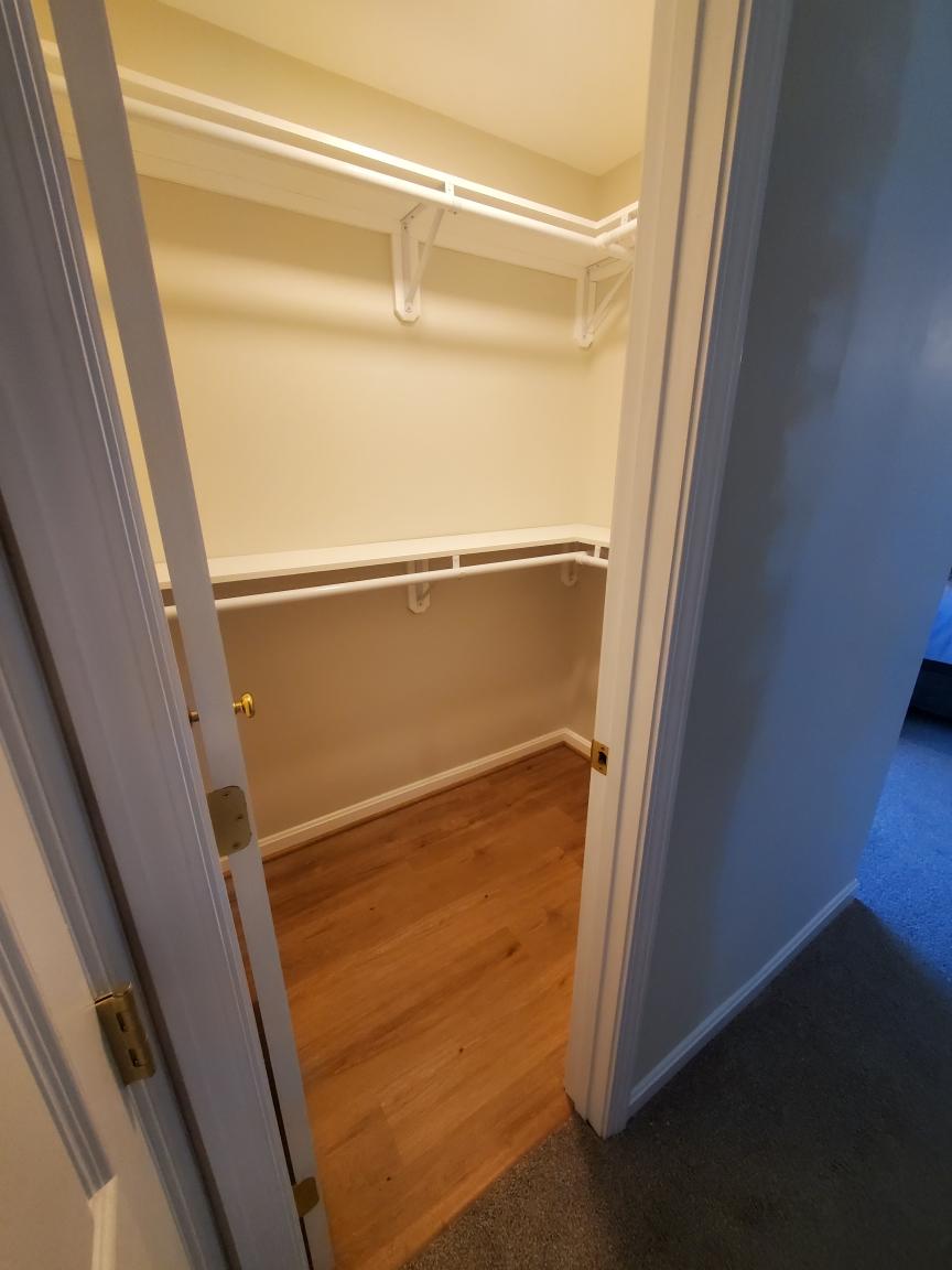 Walk-in closet with wire shelving and hardwood floor - Bradie's Custom Construction, Fredericksburg VA